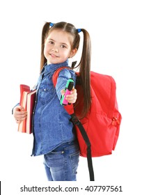 Little Girl With Red Back Pack Holding Books And Stationery, Isolated On White