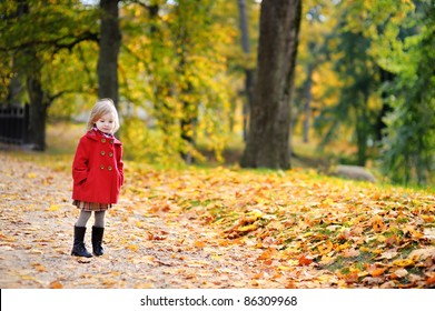 Little Girl In A Red Coat At Autumn