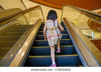 Little girl rides the elevator