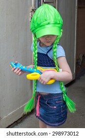 Little Girl Rock Star In Wig Play Guitar