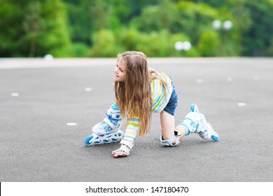 Little Girl In Roller Skates Getting Up To Move On