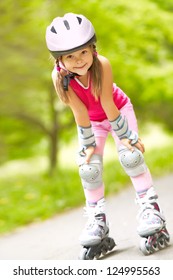 Little girl in roller skates at a park
