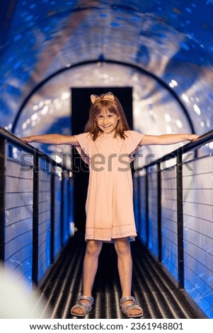 Little girl in a room that shows the universe and gravity, visiting science museum. Concept of children's entertainment and learning