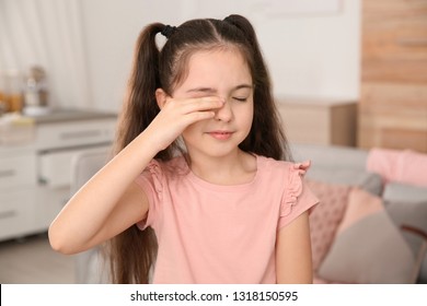 Little Girl Rubbing Eye At Home. Annoying Itch