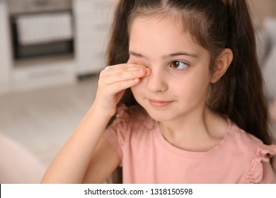 Little Girl Rubbing Eye At Home. Annoying Itch