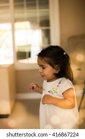 Little Girl Running Around Inside A Home.