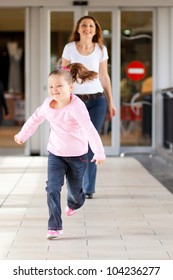 Little Girl Running In Front Mother