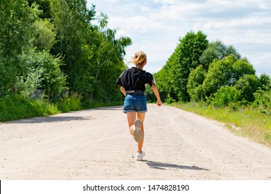 A Little Girl Running On The Road