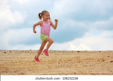 Little Girl Running In  Sand