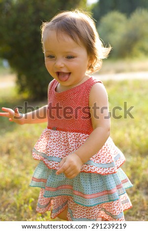 Similar – small girl wearing a hat singing happily