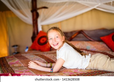 Little Girl In Safari Tent Enjoying  Luxury Vacation In Africa