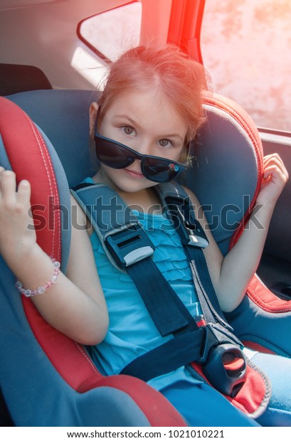 Little girl in a safety car seat.\
Safety and security. Safe driving. Child transportation safety.\

