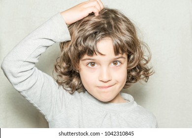 Little Girl Scratching Her Head