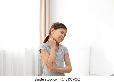 Little Girl Scratching Neck Indoors. Allergy Symptoms