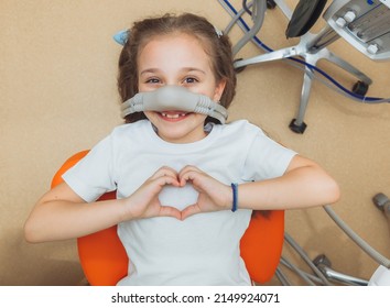 little girl with sedation mask. Treatment of children's teeth with nitrous oxide. children's dentistry. - Shutterstock ID 2149924071