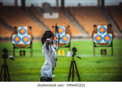 Little Girl Shoot On Archery Competition In Rainy Day