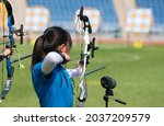 Little girl shoot at outdoor archery competition