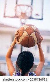 Little Girl Shooting Basket And Playing Basketball At Home