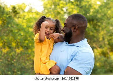 Little Girl Showing Her Dad Her Muscles.