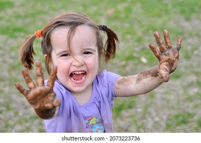 Little Girl Shows Off Her Muddy Hands With A Scream.