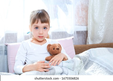 little girl is sick in bed with a teddy bear. Fever Concept. treatment is fun. medical education concept. - Shutterstock ID 1675506826