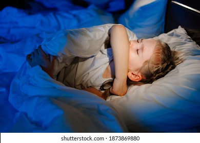 The Little Girl Is Sick, Lies In Bed And Coughs. Caring For Children. Restless Sleep During Illness. Cough Medicine.