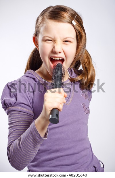 Little Girl Singing Using Hairbrush Microphone Stock Photo (Edit Now ...