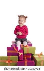 little girl sitting between a lot of presents. On white background