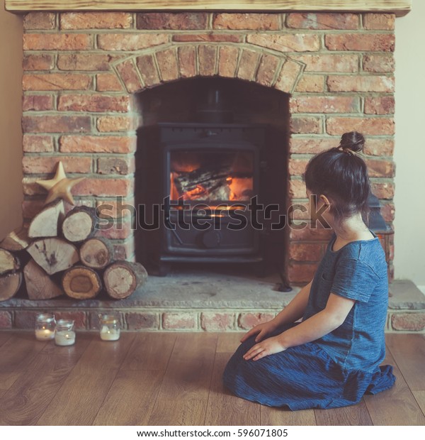 Little Girl Sitting Front Fireplace Looking Stock Photo Edit Now