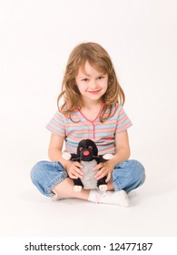 Little Girl Sitting And Holding A Plush Toy