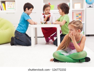 Little Girl Sitting Lonely - Feeling Excluded By The Others