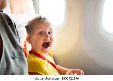 Little Girl Sitting Next To Mother Screaming On Airplane