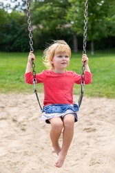 Little girl playing in the zip | People Images ~ Creative Market