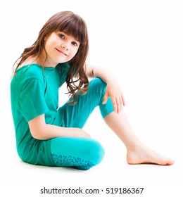 LITTLE GIRL SITTING AND SMILING HAPPY ISOLATED ON WHITE BACKGROUND