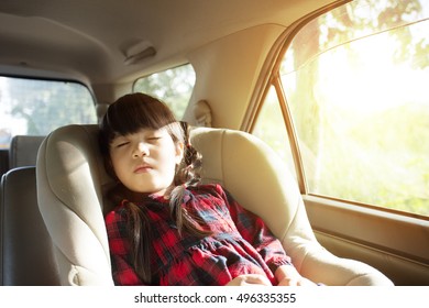 little girl sleeping in child car seat