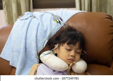 A Little Girl Is Sleeping And Doing A Neurofeedback Exam. Making EEG Electrodes.