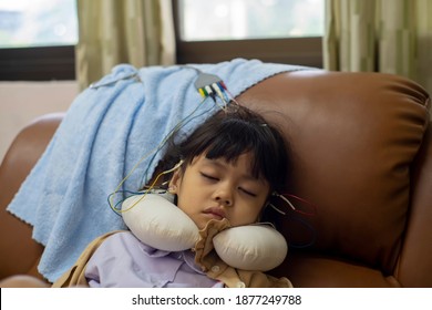 A Little Girl Is Sleeping And Doing A Neurofeedback Exam. Making EEG Electrodes.