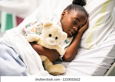 Little girl sleeping in a hospital bed - Powered by Shutterstock