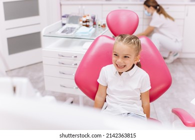 Little girl smiling on a visit to the dentist at the dental clinic - Powered by Shutterstock