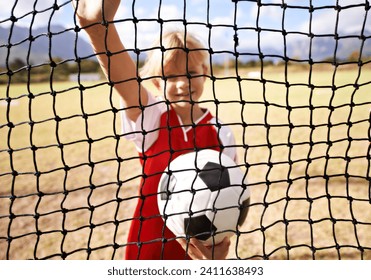 Little girl, soccer player and ball on goal net, smile and happy for game, field and child. Outdoor, playful or sport for childhood, portrait and athlete for match, alone or outside on football pitch - Powered by Shutterstock