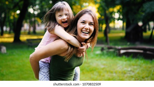 Little girl with special needs enjoy spending time with mother - Shutterstock ID 1070832509
