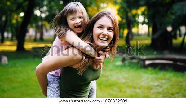 Little girl with special needs enjoy spending time
with mother
