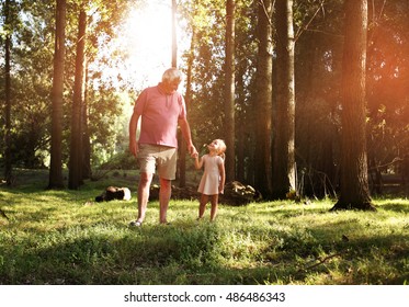 Little girl spending time with grandfather in the park. - Powered by Shutterstock