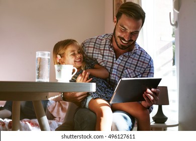 Little girl spending time with her father at home. - Powered by Shutterstock