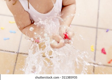 Little Girl Splashing A Water Ballon. Concept About End Of The Summer