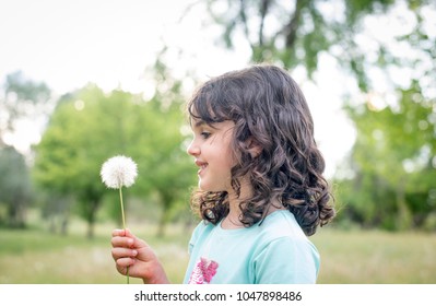 Little girl springtime in the park, posing for the photographer
