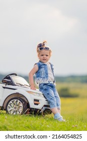 Little Girl Standing Near Her Baby Car