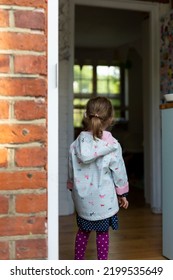 Little Girl Standing On The Porch And Looking Inside House