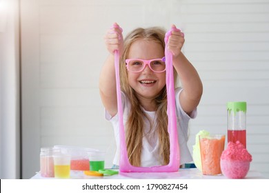  Little Girl Stretching Pink Slime To The Sides. Kids Hands Playing Slime Toy. Making Slime. Copyspace. 