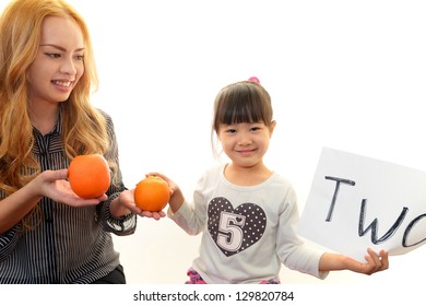 Little Girl Studying In English With Teacher